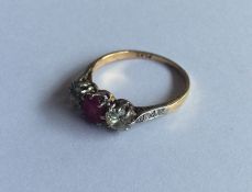 A large ruby and diamond three stone ring in 18 ca