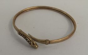 A 9 carat bracelet in the form of an entwined snak