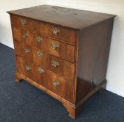 An attractive oyster veneered chest of five drawer