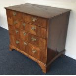 An attractive oyster veneered chest of five drawer