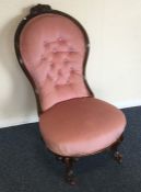 A Victorian button back mahogany nursing chair. Es