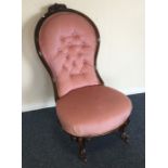 A Victorian button back mahogany nursing chair. Es