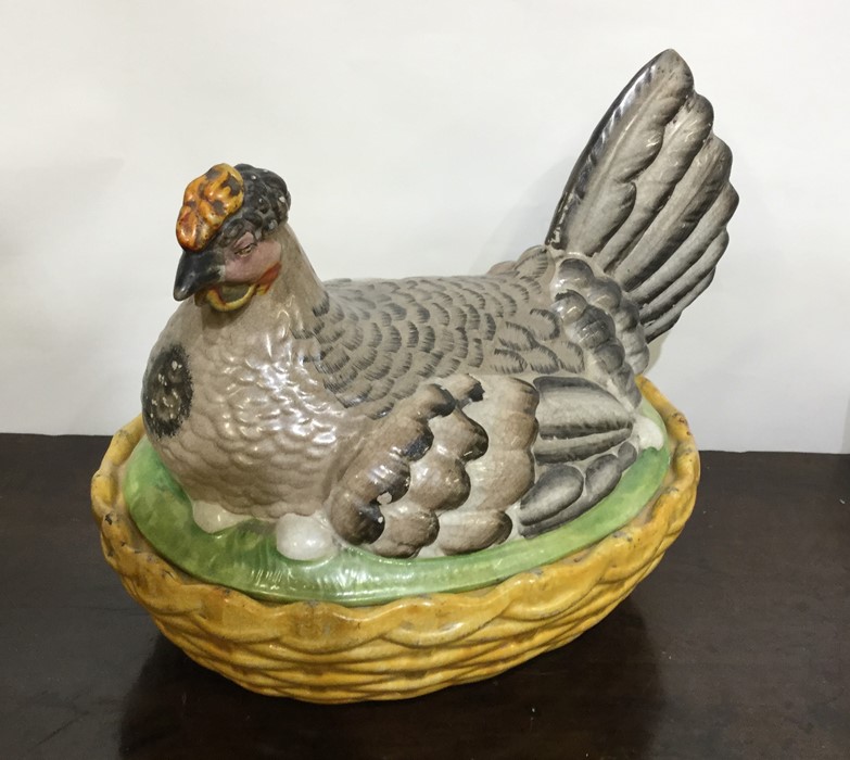 A large pottery egg bowl fashioned as a sitting he