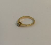 A small gold single stone diamond ring in claw mou