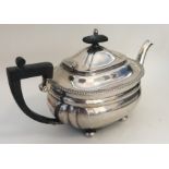 A heavy Edwardian silver teapot on ball feet. Birm