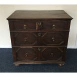 An Antique oak chest of four drawers on bun feet.