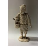 A carved ivory figure of an Oriental man on rectan