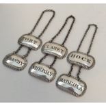 A rare set of six Georgian silver wine labels with