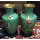 A large pair of brass and cloisonné vases on woode