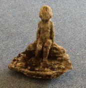 A small garden statue of a seated child. Est. £20