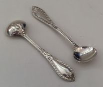 A pair of fine quality cast silver salt spoons wit