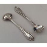 A pair of fine quality cast silver salt spoons wit