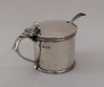 An Edwardian silver drum mustard with hinged top.