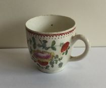 An Antique coffee cup decorated with flowers and l