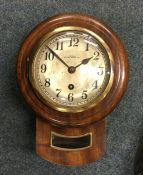 A small mahogany cased wall clock. By Dossor of We