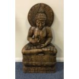 A large heavy carved wooden figure of a Buddha in