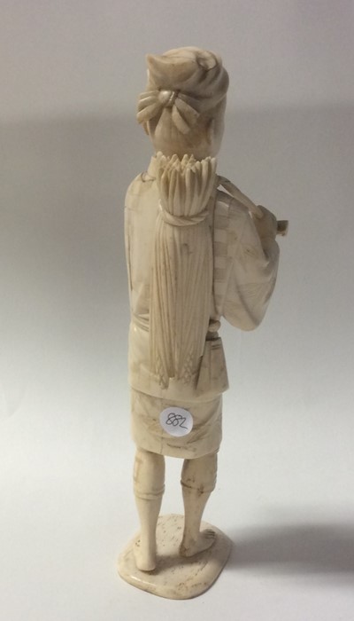 A carved ivory model of an Oriental man in standin - Image 2 of 2