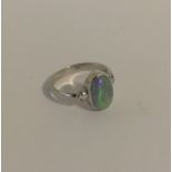 An attractive opal single stone ring in 18 carat g