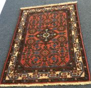 A small Oriental rug. Est. £25 - £35.