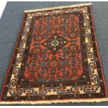 A small Oriental rug. Est. £25 - £35.