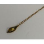 An amber and gold mounted necklace on fine link ch