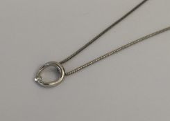 An 18 carat gold diamond single stone pendant on s