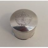A rare circular silver box with lift-off cover, in