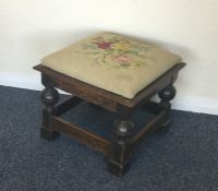 A small oak stool with tapestry seat. Est. £20 - £