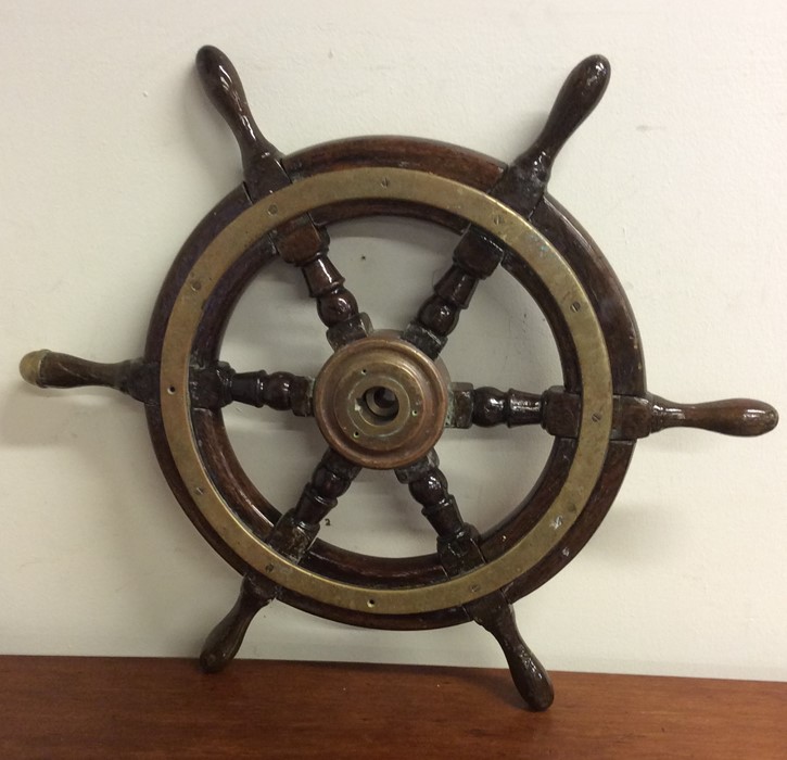 An Antique brass mounted ship's wheel. Est. £50 -