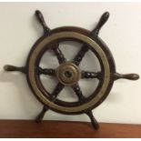 An Antique brass mounted ship's wheel. Est. £50 -