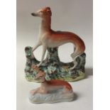 A Staffordshire figure of a greyhound together wit