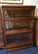 An oak three stack Globe Wernicke bookcase. Est. £