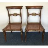 An attractive pair of Regency dining chairs with b