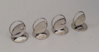 An unusual set of four silver menu holders in the