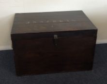 A hardwood hinged top trunk. Est. £30 - £50.