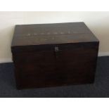 A hardwood hinged top trunk. Est. £30 - £50.