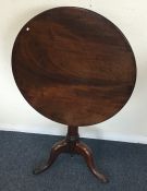 A Georgian mahogany tripod table on three sweeping