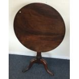 A Georgian mahogany tripod table on three sweeping