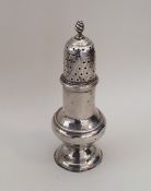 A Georgian silver caster with lift-off cover. Lond