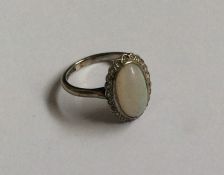A good oval opal and diamond cluster ring in plati