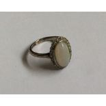 A good oval opal and diamond cluster ring in plati