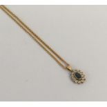 A 9 carat diamond and sapphire oval pendant on fin