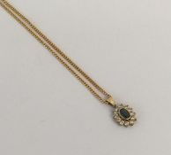 A 9 carat diamond and sapphire oval pendant on fin