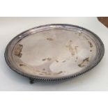 A heavy Edwardian silver salver with gadroon rim.