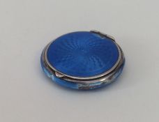 A silver and enamel compact with fitted interior.