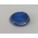 A silver and enamel compact with fitted interior.