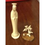 A carved ivory figure of a tree with seated birds