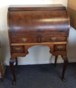 A 20th Century walnut cylinder top bureau. Est. £3