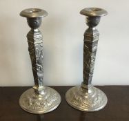 A pair of tapering Chinese candlesticks decorated