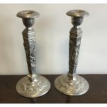 A pair of tapering Chinese candlesticks decorated